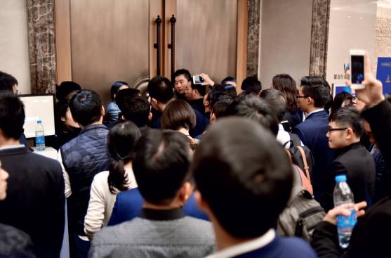 贾跃亭闭门演讲时，门外挤满了人，不时有人咚咚砸门，要求进场。摄影 | 史小兵